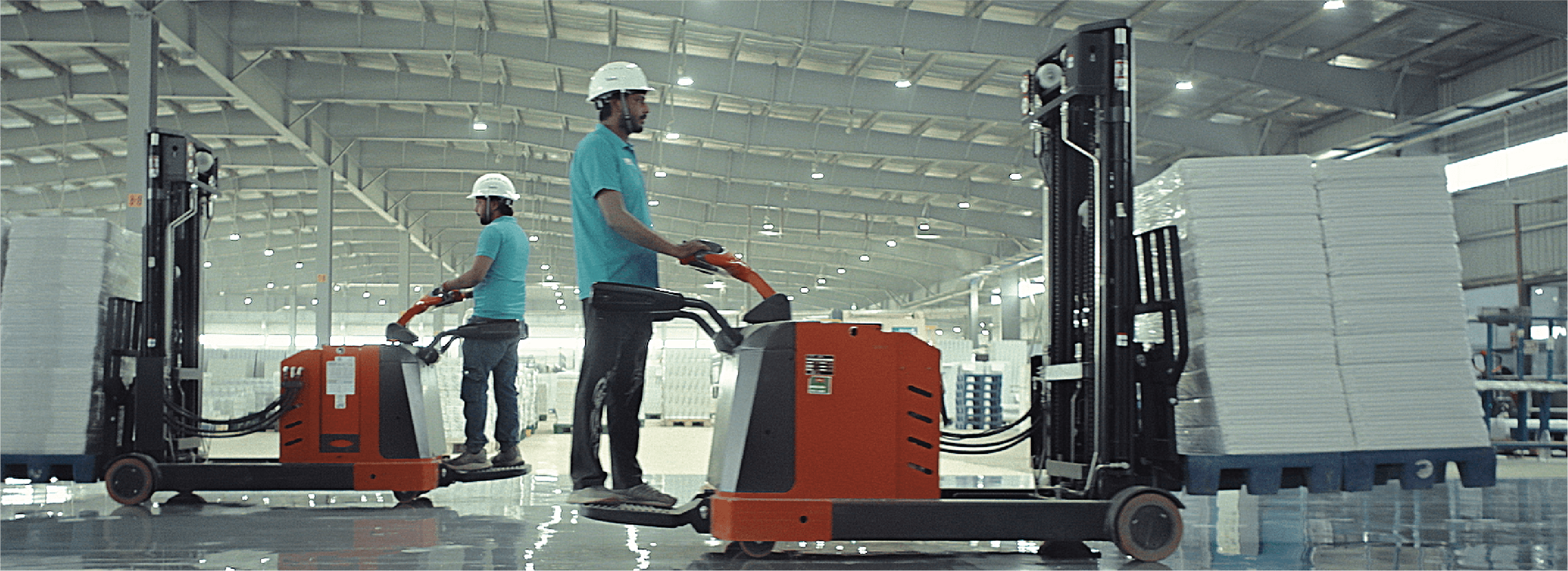 Naini team members moving paper stock inside the facility