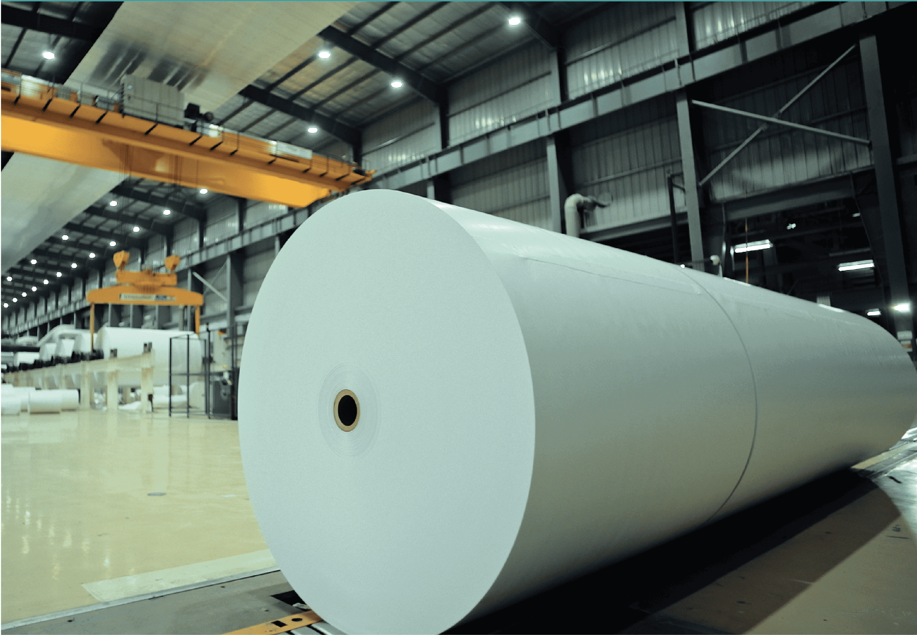 Large white paper roll inside the Naini manufacturing facility